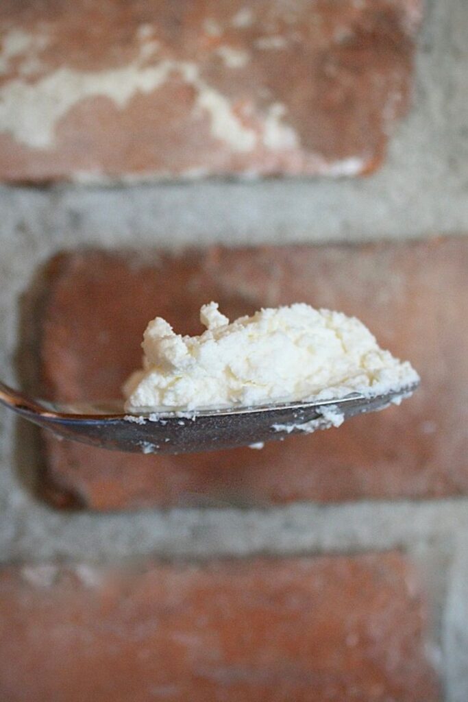 Quark, a German cream cheese, on a spoon.